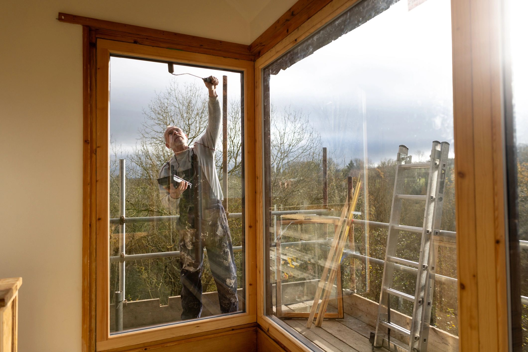 Maintenance professional painting the exterior of a house