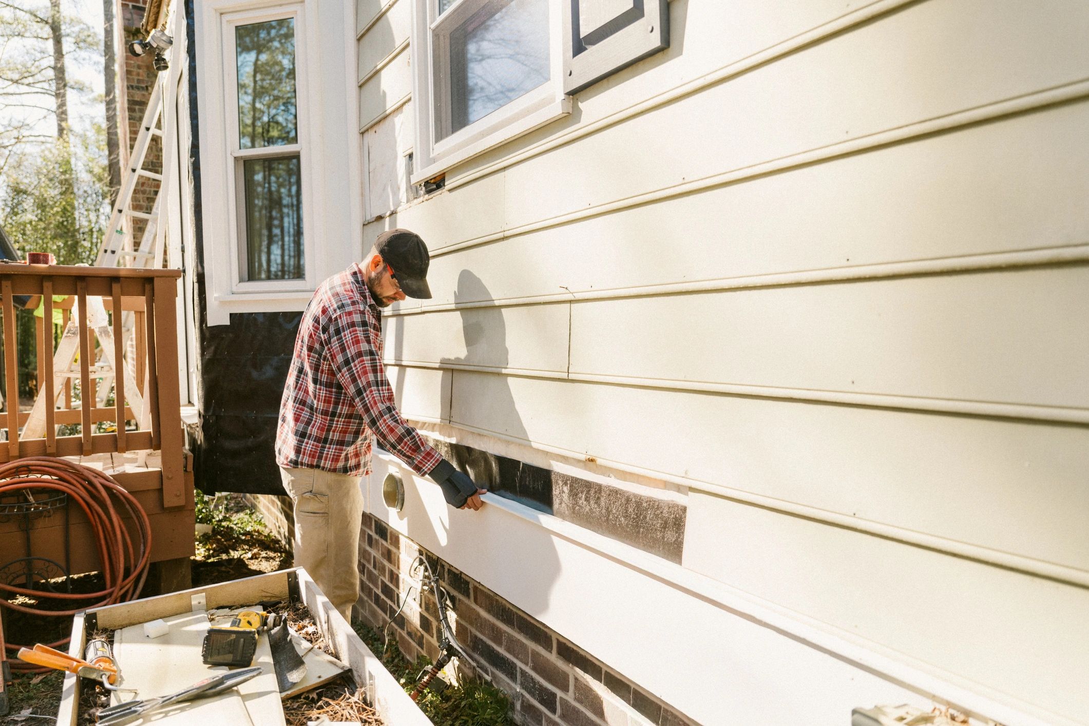 Property maintenance professional working on an exterior building
